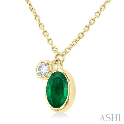 1/20 ctw Oval Cut 6X4MM Emerald and Bezel Set Round Cut Diamond Precious Necklace in 14K Yellow Gold