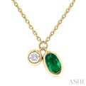 1/50 ctw Oval Cut 6X4MM Emerald and Bezel Set Round Cut Diamond Precious Necklace in 10K Yellow Gold