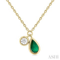 1/50 ctw Pear Cut 6X4MM Emerald and Bezel Set Round Cut Diamond Precious Necklace in 10K Yellow Gold