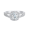 Cushion halo is a stunning way to showcase the round solitaire diamond. Modern split diamond studded shank further highlights the center.