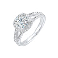 Cushion halo is a stunning way to showcase the round solitaire diamond. Modern split diamond studded shank further highlights the center.