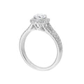 Cushion halo is a stunning way to showcase the round solitaire diamond. Modern split diamond studded shank further highlights the center.