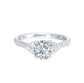 A trio of round diamonds on either side of the solitaire followed by a diamond studded shank, this ring is sure to impress her.