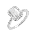 A beautiful emerald cut solitaire set with halo of round diamonds and a diamond studded shank makes this perfect choice of your love story.