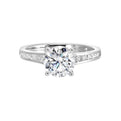 The simplicity of this single row channel set diamond shank engagement ring with four prong solitaire is simply gorgeous.