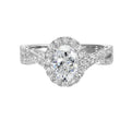 Shimmers of entwined shank with a classic halo and round center diamond is sure to delight you.